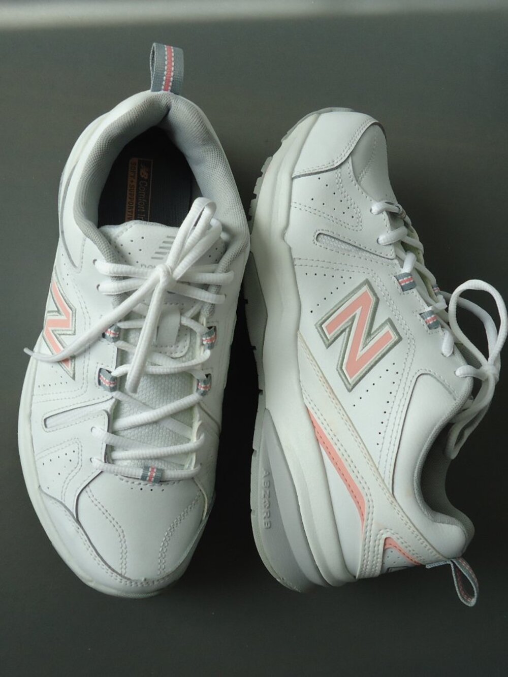 SIZE 9.5. D. New Balance women's white leather sneakers shoes.